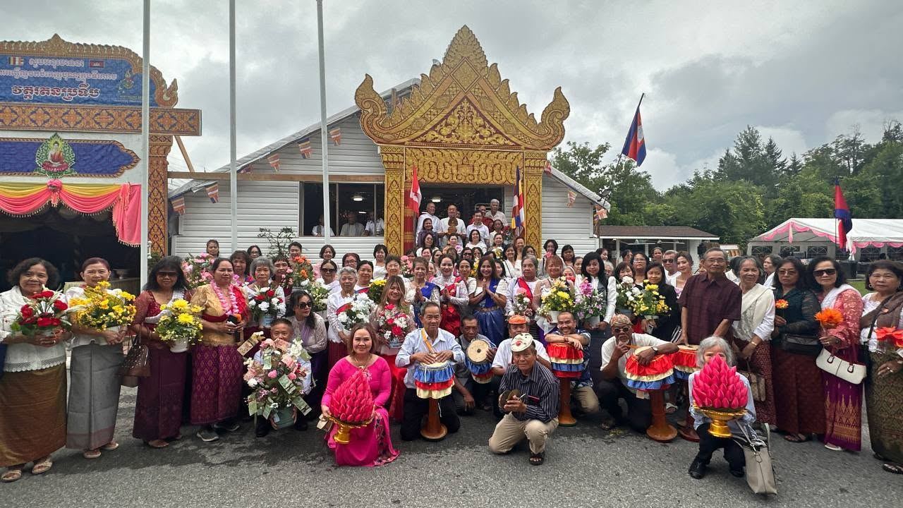 The community gathered in front of the golden temple gate with flowers and drums